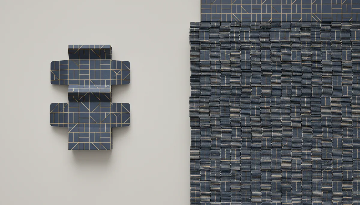 Comparison of single digital print sample versus large stack of offset printed packaging boxes